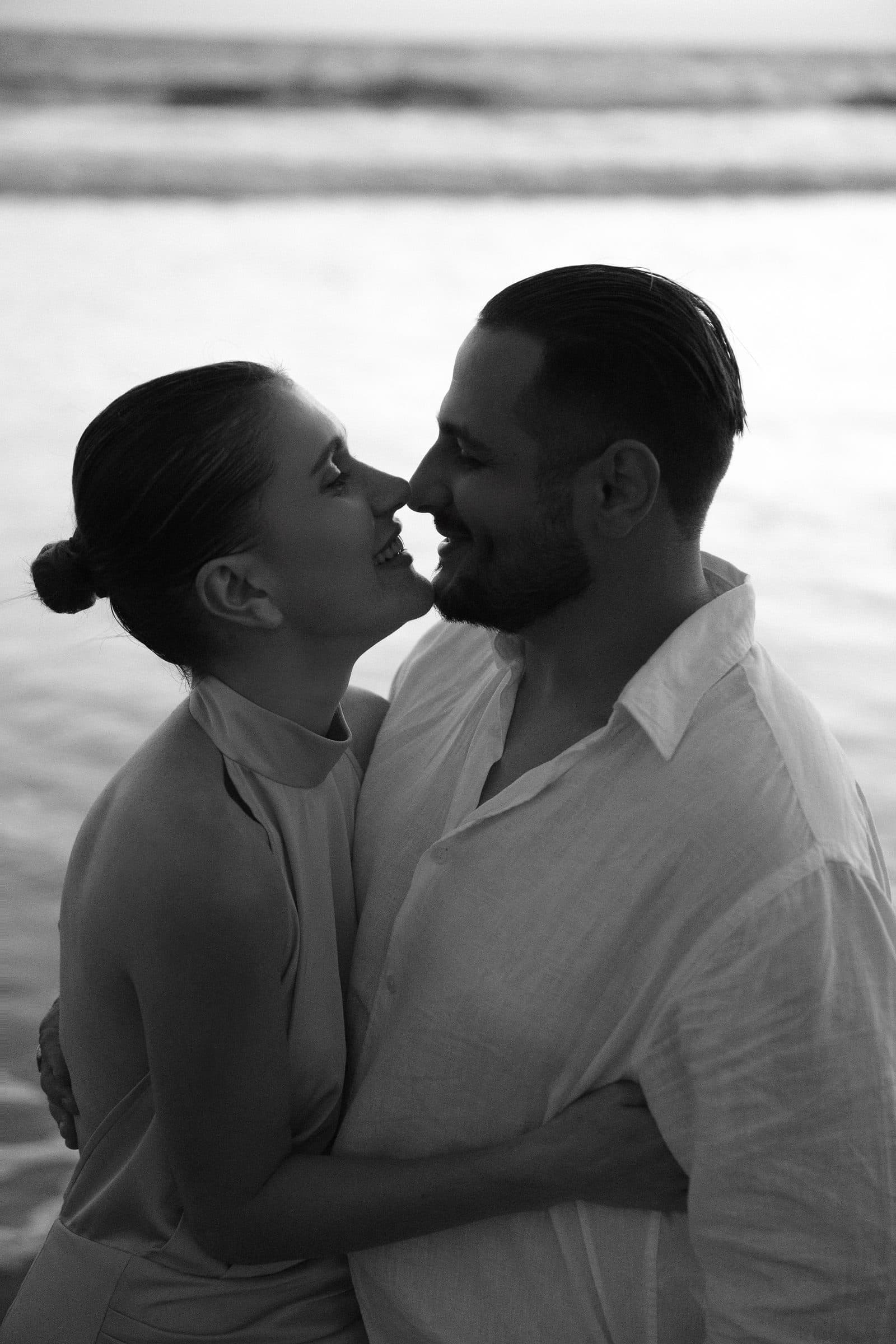 The couple standing forehead to forehead, photographed in black and white